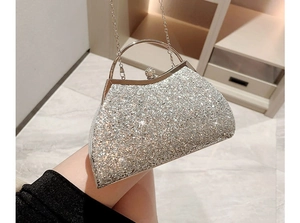 Close-up of sparkling silver evening shell clutch with glitter texture and ring handle