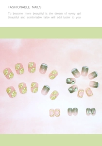 Detail of pink and green gradient press-on nails with 3D green heart charms and lime patterns