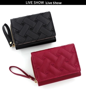 Detail of short PU leather wallets with heart embroidery and golden zipper closures