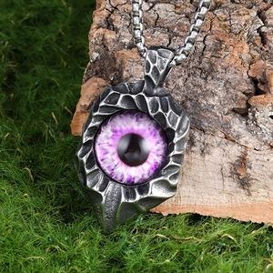 Detailed view of purple evil eye pendant with hammered stainless steel texture on moss