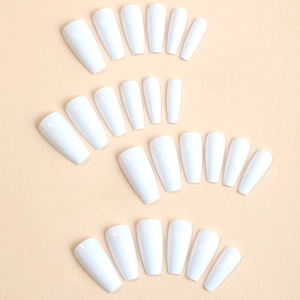 Long coffin solid white glossy press-on nails set in varied sizes on a beige base