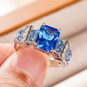 Macro detail of royal style square blue sapphire ring with micro paved side stones