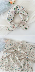 Detail of floral cotton linen neck scarf with rabbit pattern and soft brown borders