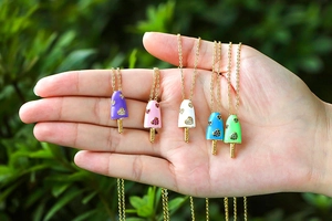 Macro detail of ice cream shaped pendants with heart crystals and colorful enamel finish