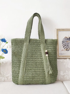 Large forest green woven straw tote bag with wood bead tassel and fringe details