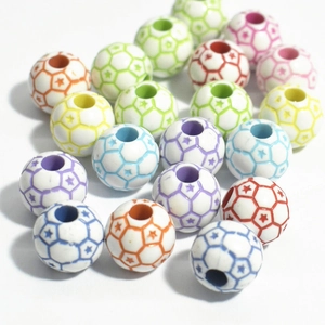 Close-up of colorful soccer-shaped acrylic beads with star patterns for jewelry making
