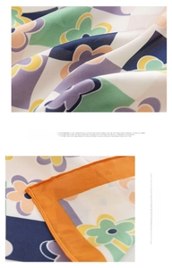 Detailed close-up of geometric floral silk scarf featuring soft breathable fabric textures