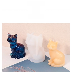 Detailed view of cat-shaped silicone mold with finished resin and candle animal figures