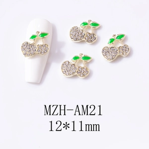 Detail showing 3D alloy cherry nail charms with rhinestones and green enamel leaf detail