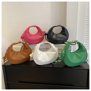 Detail view of crescent hobo bags in various colors with knotted handle and gold hardware