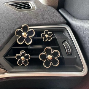 Set of 4 black daisy flower car vent clips with gold trim for dashboard decoration