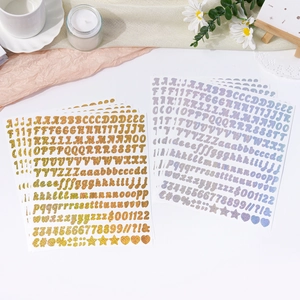 Close-up of sparkling gold and silver glitter alphabet and number stickers for decoration