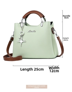 Detail view of green pebble PU leather tote with dimensions 25x12x20cm and metal logo