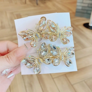 Set of two butterfly crystal hair clips with gold alloy base on white display card