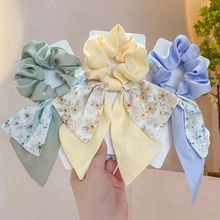 Three-piece set of floral ribbon scrunchies with soft bow design for hair styling