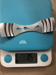 Detail shot of stainless steel buckle weighing 15.4g on a digital scale for bags