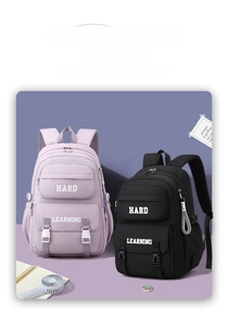 Detail view of stylish school backpacks in purple and black with multiple zip pockets