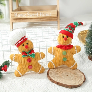 Plush corduroy gingerbread man dolls in warm orange for Christmas window decor