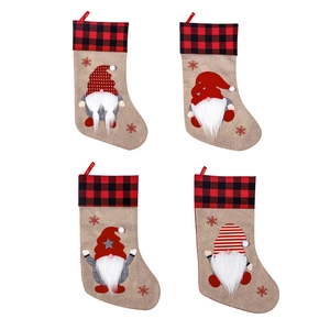 Set of four Nordic gnome Christmas stockings with red plaid cuffs and hanging loops