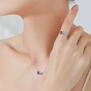 Elegant S925 sterling silver jewelry set featuring blue sapphire necklace and open ring