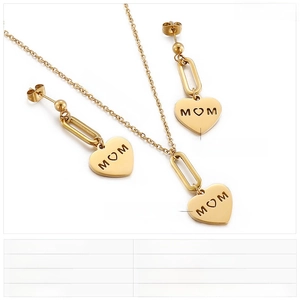 Detailed view of gold stainless steel heart necklace and earrings set with MOM engraving