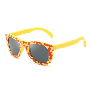 Yellow giraffe print kids sunglasses with dark grey round lenses on white background