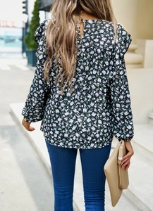 Rear view of floral long sleeve shirt with ruffle shoulder and back button closure detail