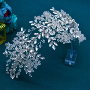 Close-up of bridal headband with intricate silver wire flowers and crystal rhinestones