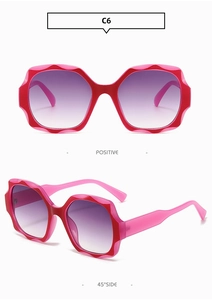 Close-up of C6 square wavy frame sunglasses with pink-red frames and purple gradient lenses