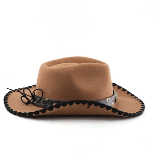 Detail of wool felt cowboy hat with braided edges and metal studded leather band