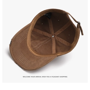 Detail view of brown washed cotton baseball cap interior with white stitching and sweatband