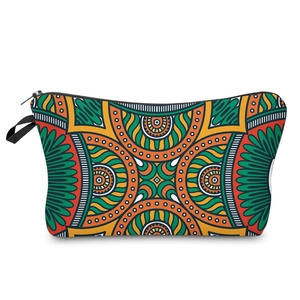 Portable makeup bag featuring colorful ethnic geometric patterns and black zipper closure