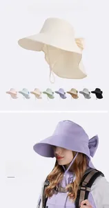 Detail of wide brim sun hat with neck flap, bow decoration and windproof drawstring