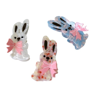 Cute rabbit hair clips set with pink bows in white and patterned acetate finish