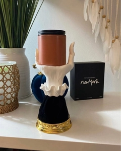 Detail of creative witch hand tray with a candle jar and gold embossed base for Halloween