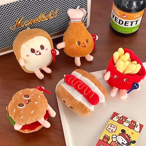 Cute plush fast food charms including burger, fries, and hotdog on a wooden table