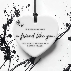 Close-up of heart ceramic ornament with sentimental English quote and black ribbon