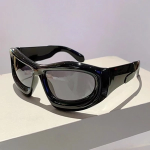 Detail view of glossy black Y2K sunglasses with dark lenses on a white display