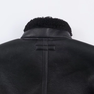 Close-up of black leather jacket back collar with premium faux shearling wool texture