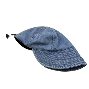 Detail of washed denim sun hat with wide brim stitching and adjustable toggle cord