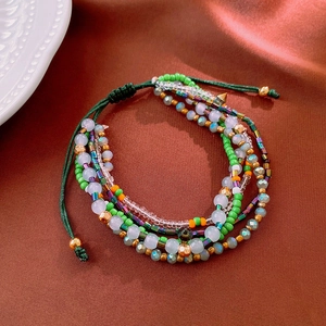 Detail view of Bohemian multi-layer beaded bracelet with adjustable woven strap