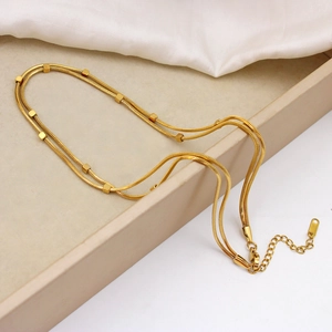 Detail of 18K gold-plated double-layer snake chain with square beads and lobster clasp