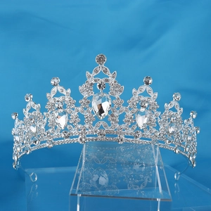 Silver bridal crown featuring noble black gemstones and sparkling rhinestones on blue background