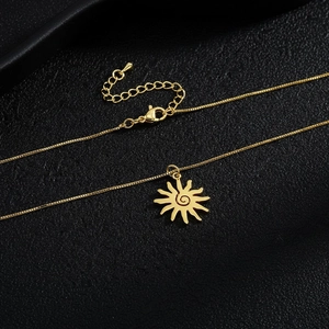Detailed close-up of golden sun pendant necklace with zircon inlay on leather texture