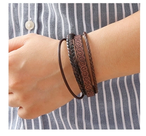 Close-up of brown multi-layer PU leather braided bracelet with S-shape pattern on wrist