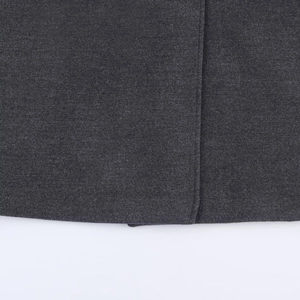 Close-up of charcoal grey wool coat fabric texture and precise stitching details