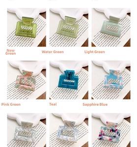 Detailed grid showing colorful acetate hair claws in green and marble textures
