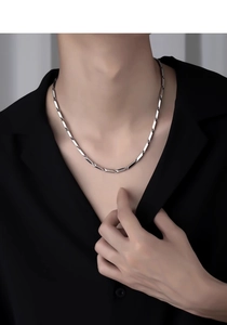 Silver rectangular link necklace shown on model neck in minimalist street style