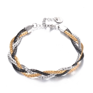 Detail of tricolor braided stainless steel bracelet with gold, silver, and black metal strands