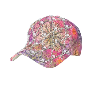 Pink floral baseball cap with pearls and silver studs on a clean white background